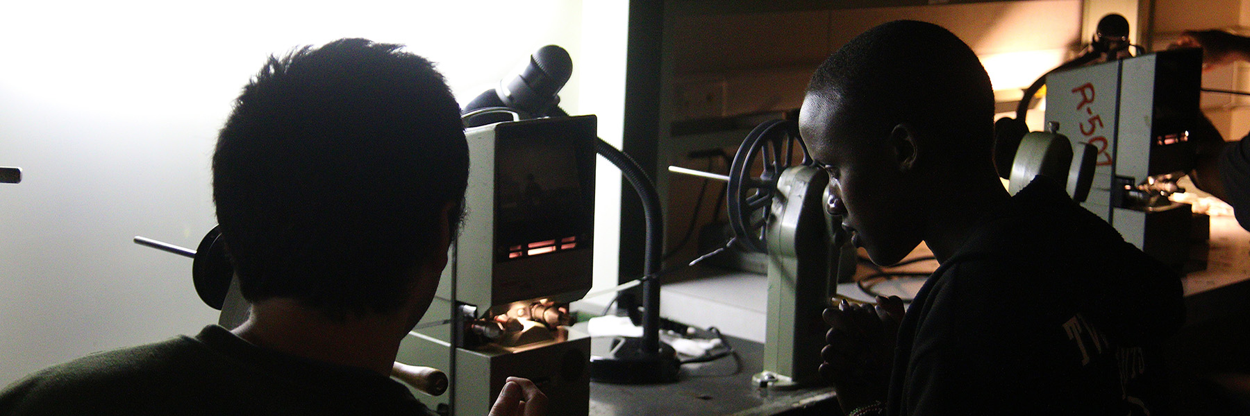 Photo of two students working on film editing