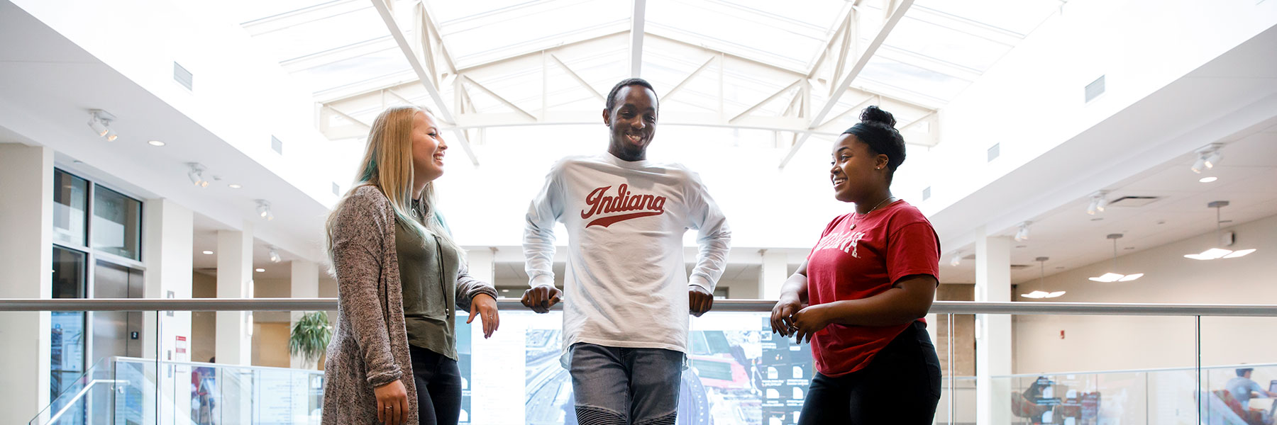 Three people standing on the second floor of the Franklin Hall commons